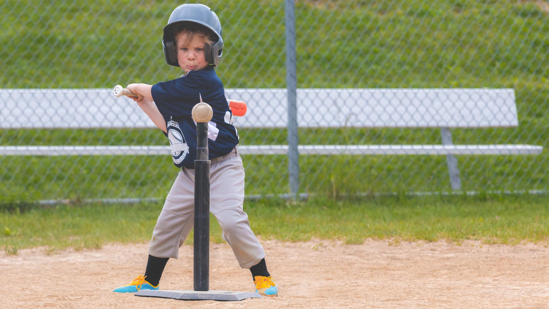 kid hitting baseball